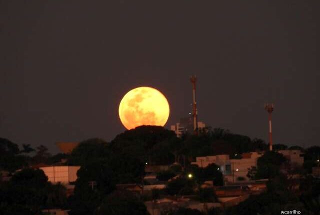 Lua cheia nasce alaranjada e colore o céu de Campo Grande